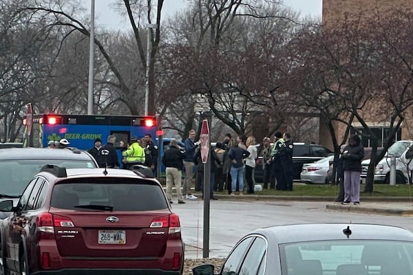 Emergency vehicles are parked outside of the SSM Health clinic where parents are being reunified with children after a shooting at the Abundant Life Christian School in Madison, Wis., Monday, Dec. 16, 2024. (AP Photo/Scott Bauer)