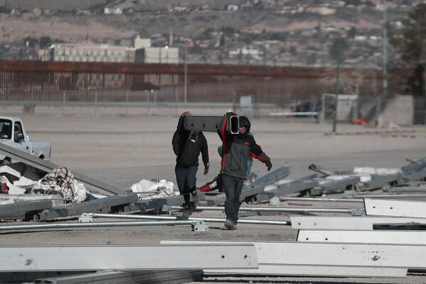 Workers begin the installation of a temporary shelter for possible deportees from the United States, in Ciudad Juarez, Mexico, Wednesday, Jan. 22, 2025. (AP Photo/Christian Chavez)