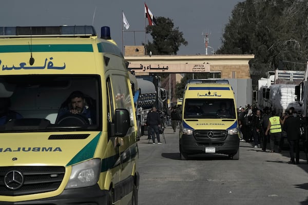 Ambulances pass in front of the Rafah border crossing between Egypt and the Gaza Strip , Sunday, Jan. 19, 2025. (AP Photo/Amr Nabil)