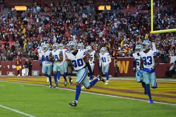 Dallas Cowboys safety Juanyeh Thomas (30) celebrates after scoring a 43-yard touchdown off a kickoff return during the second half of an NFL football game against the Washington Commanders, Sunday, Nov. 24, 2024, in Landover, Md. (AP Photo/Stephanie Scarbrough)