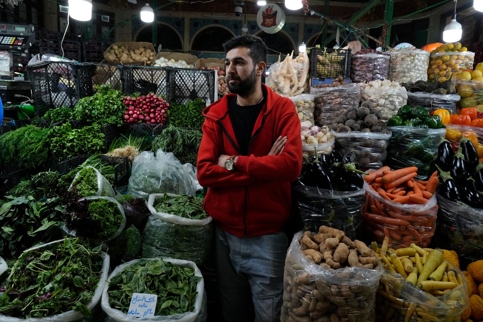 A grocery seller waits for customers at Tajrish traditional bazaar in northern Tehran, Iran, Saturday, Oct. 26, 2024. (AP Photo/Vahid Salemi)