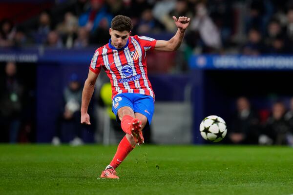 Atletico Madrid's Julian Alvarez shoots to score the opening goal during the Champions League opening phase soccer match between Atletico Madrid and Slovan Bratislava at Riyadh Air Metropolitano stadium in Madrid, Spain, Wednesday, Dec. 11, 2024. (AP Photo/Manu Fernandez)