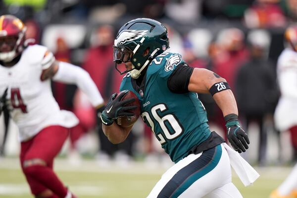 Philadelphia Eagles running back Saquon Barkley runs for a touchdown against the Washington Commanders during the first half of the NFC Championship NFL football game, Sunday, Jan. 26, 2025, in Philadelphia. (AP Photo/Chris Szagola)