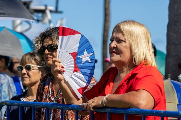 People listen to new Governor Jenniffer Gonzalez Colon speak after she was sworn-in as governor outside the Capitol in San Juan, Puerto Rico, Thursday, Jan. 2, 2025. (AP Photo/Alejandro Granadillo)