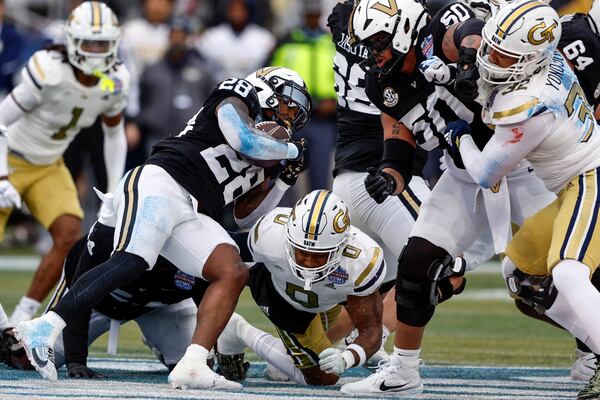 Vanderbilt running back Sedrick Alexander (28) carries the ball as Georgia Tech linebacker Trenilyas Tatum (0) defends during the first half of the Birmingham Bowl NCAA college football game, Friday, Dec. 27, 2024, in Birmingham, Ala. (AP Photo/Butch Dill)