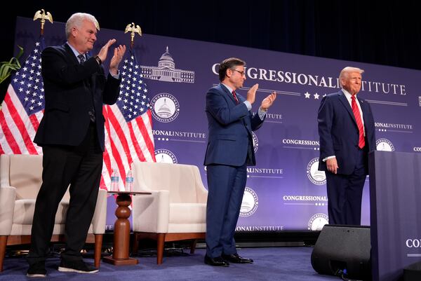 Rep. Tom Emmer, R-Minn., left, and House Speaker Mike Johnson of La., applaud President Donald Trump at the 2025 House Republican Members Conference Dinner at Trump National Doral Miami in Doral, Fla., Monday, Jan. 27, 2025. (AP Photo/Mark Schiefelbein)