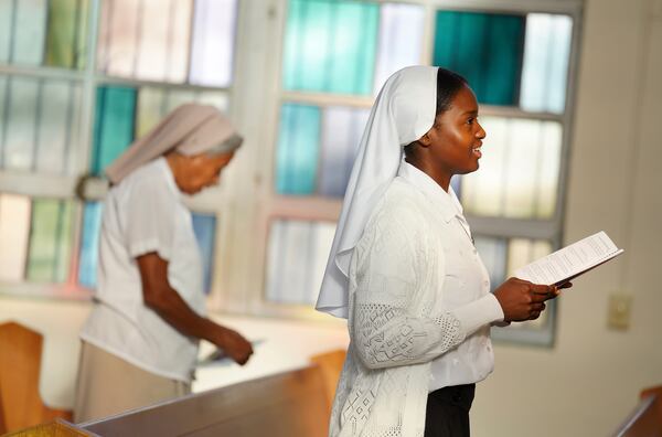 Sister Seyram Mary Adzokpa, right, of the Sisters of the Holy Family, sings during morning Mass at the motherhouse, in New Orleans, Wednesday, June 26, 2024. (AP Photo/Jessie Wardarski)