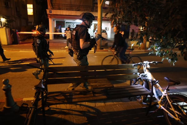 Israeli forces work at the scene of a stabbing attack in Tel Aviv, Israel, Tuesday, Jan. 21, 2025. (Tomer Appelbaum /Haaretz via AP)