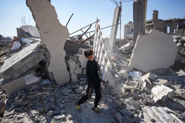 Youssef Muqdad salvages items from under the rubble of his destroyed family home, in Rafah, southern Gaza Strip, Tuesday, Jan. 21, 2025, days after the ceasefire deal between Israel and Hamas came into effect. (AP Photo/Abdel Kareem Hana)