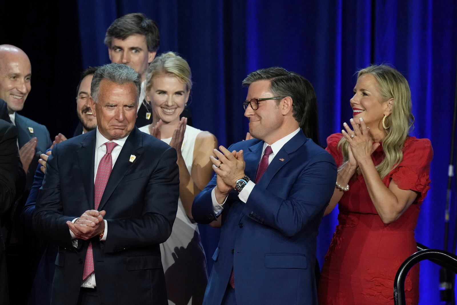 House Speaker Mike Johnson, R-La., and his wife Kelly, right, react as they listen to Republican Presidential nominee former President Donald Trump speaking at the Palm Beach County Convention Center during an election night watch party, Wednesday, Nov. 6, 2024, in West Palm Beach, Fla. (AP Photo/Lynne Sladky)