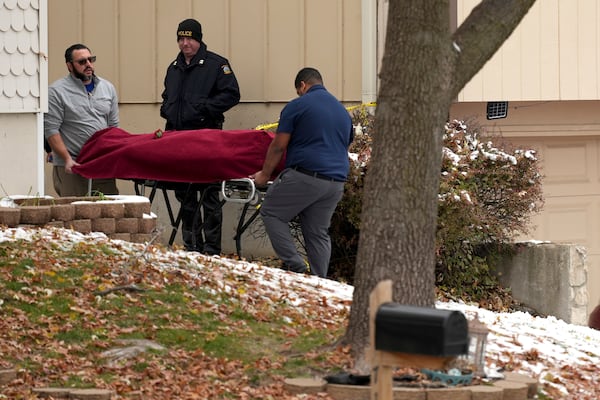 Workers carry a body from the home of former Kansas City, Kan. police detective Roger Golubski on Monday, Dec. 2, 2024, in Edwardsville, Kan. (AP Photo/Charlie Riedel)