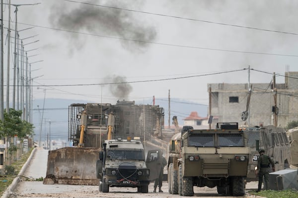 Israeli army vehicles are seen during a military operation in the West Bank city of Jenin, Wednesday, Jan. 22, 2025. (AP Photo/Majdi Mohammed)