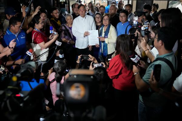 Former Senator Leila de Lima and Akbayan Partylist representative Perci Cendana show a copy of an impeachment complaint which they prepared to file against Philippine Vice President Sara Duterte as they wait for the secretary general to receive it at the House of Representatives in Quezon City, Philippines on Monday Dec. 2, 2024. (AP Photo/Aaron Favila)