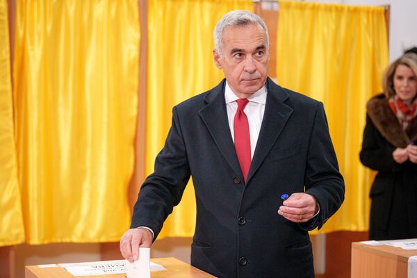 Calin Georgescu, an independent candidate for president who came first after the first round of presidential elections, casts his vote in the country's parliamentary election in Mogosoaia, Romania, Sunday, Dec. 1, 2024. (AP Photo/Andreea Alexandru)