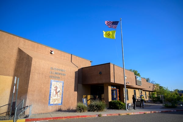 An American flag and New Mexico flag fly at Algodones Elementary School, Tuesday, Oct. 1, 2024, at Algodones Elementary School in Algodones, N.M. (AP Photo/Roberto E. Rosales)