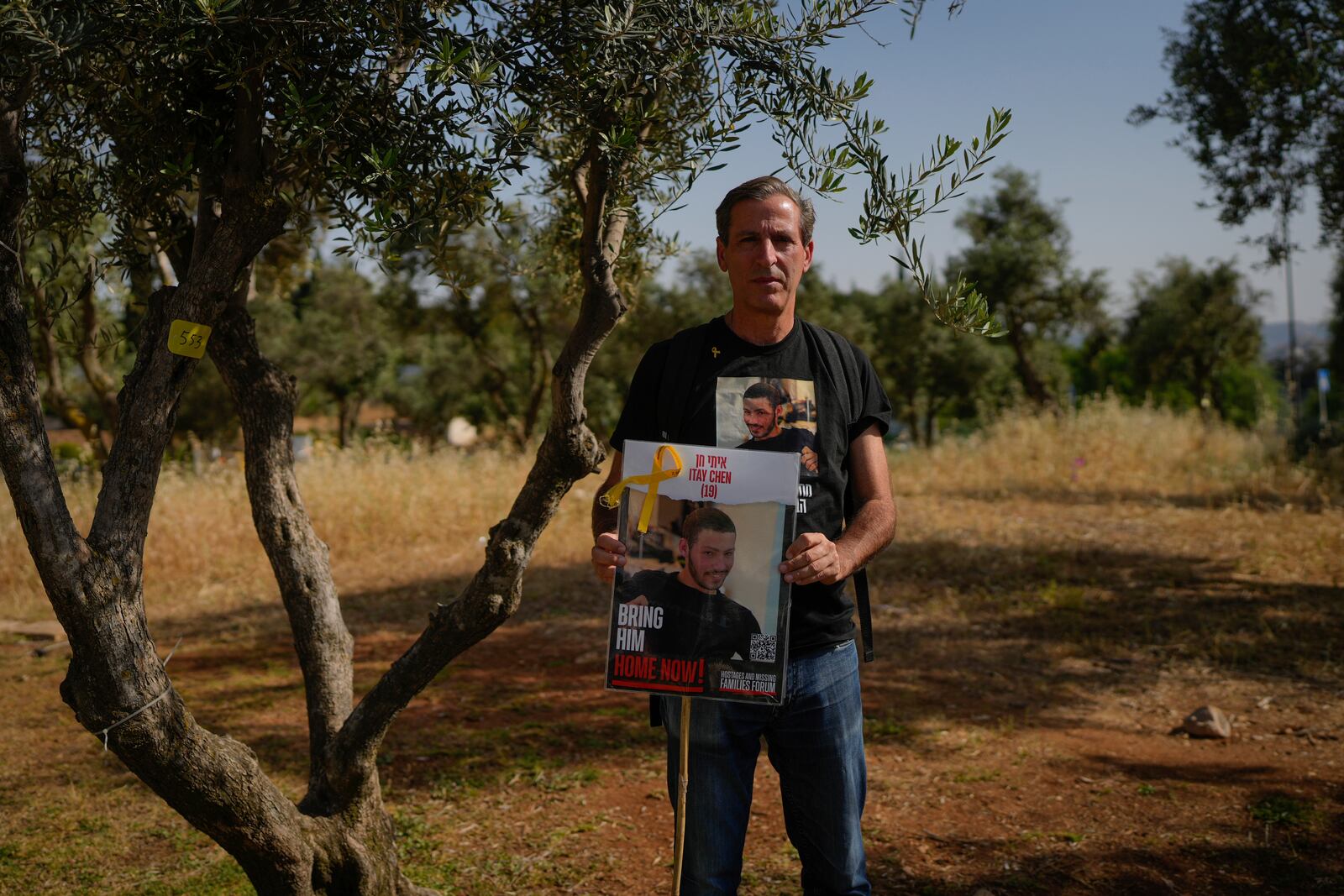 FILE - Ruby Chen holds a poster of his son, Itay Chen, during a protest near Israel's parliament in Jerusalem, on March 9, 2024. (AP Photo/Ohad Zwigenberg, File)