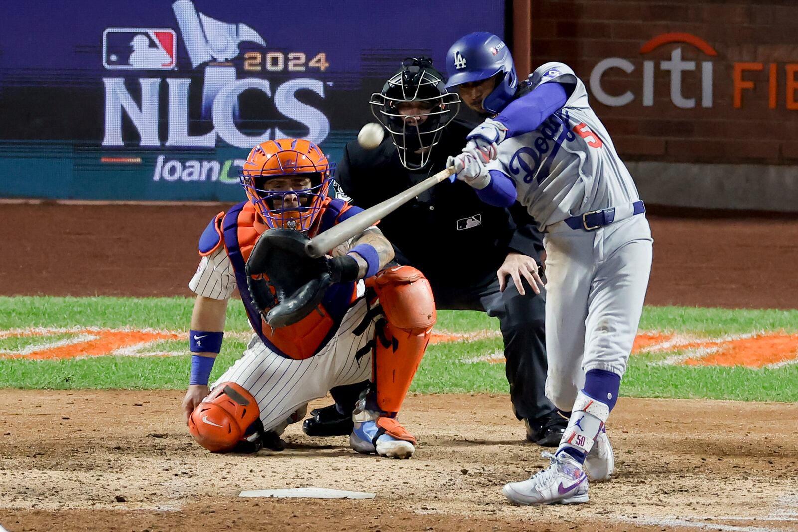 Los Angeles Dodgers' Mookie Betts hits a two-run home run against the New York Mets during the seventh inning in Game 4 of a baseball NL Championship Series, Thursday, Oct. 17, 2024, in New York (AP Photo/Adam Hunger)