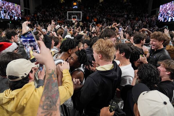 Vanderbilt players and fans celebrate the team's 76-75 win against Tennessee after an NCAA college basketball game Saturday, Jan. 18, 2025, in Nashville, Tenn. (AP Photo/George Walker IV)