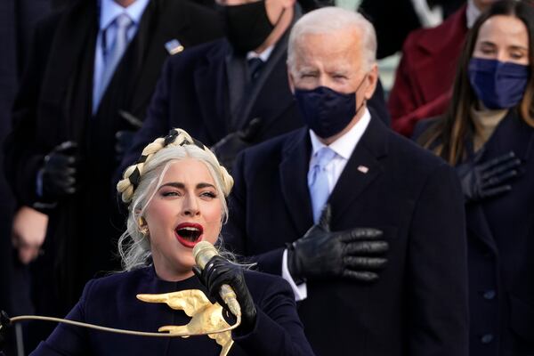 FILE - Lady Gaga performs the National Anthem as President-elect Joe Biden watches during the 59th Presidential Inauguration at the U.S. Capitol in Washington, Jan. 20, 2021. (AP Photo/Andrew Harnik, File)