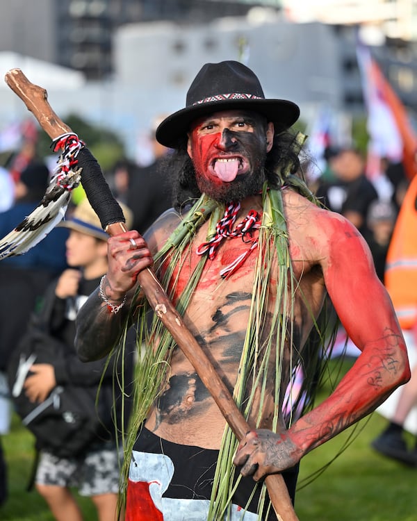 Indigenous Māori people gather at a park before marching to Parliament in Wellington, New Zealand, Tuesday, Nov. 19, 2024. (AP Photo/Mark Tantrum)