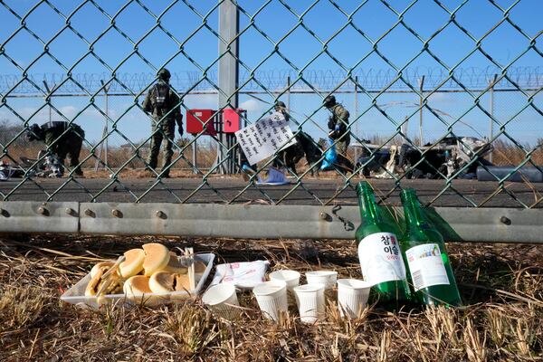 A message of condolences and foods are seen outside of Muan International Airport in Muan, South Korea, Tuesday, Dec. 31, 2024, following Sunday's plane crash. (AP Photo/Ahn Young-joon)