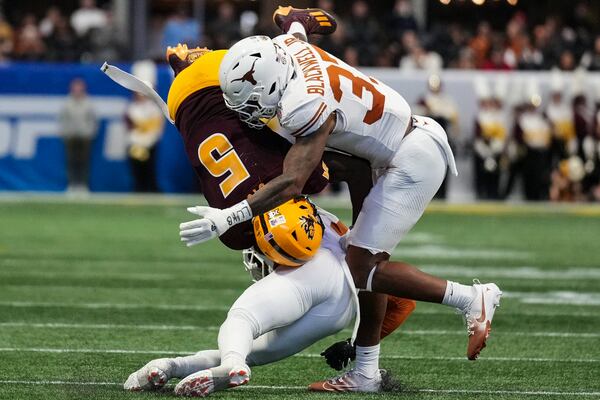 Texas linebacker Morice Blackwell Jr. (37) hits Arizona State wide receiver Melquan Stovall (5) during the first half in the quarterfinals of a College Football Playoff, Wednesday, Jan. 1, 2025, in Atlanta. (AP Photo/Brynn Anderson)