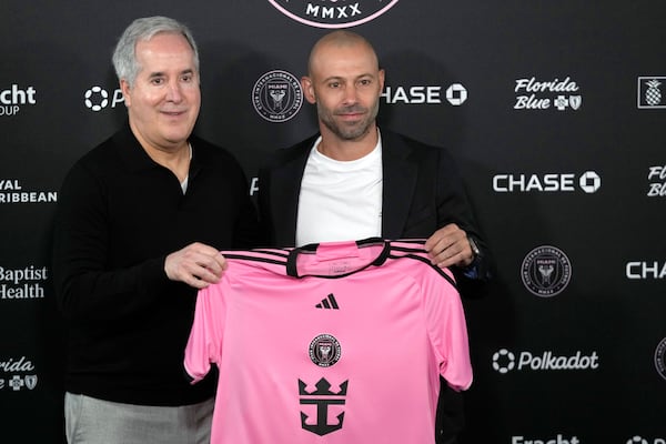 Inter Miami managing owner and CEO Jorge Mas, left, holds up a jersey as he introduces new head coach Javier Mascherano during an MLS soccer news conference, Tuesday, Dec. 3, 2024, in Fort Lauderdale, Fla. (AP Photo/Wilfredo Lee)