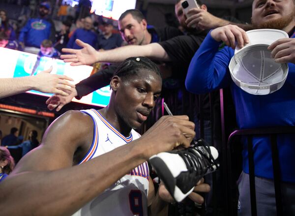 Florida center Rueben Chinyelu (9) signs a shoe after defeating Tennessee 73-43 in an NCAA college basketball game Tuesday, Jan. 7, 2025, in Gainesville, Fla. (AP Photo/Alan Youngblood)