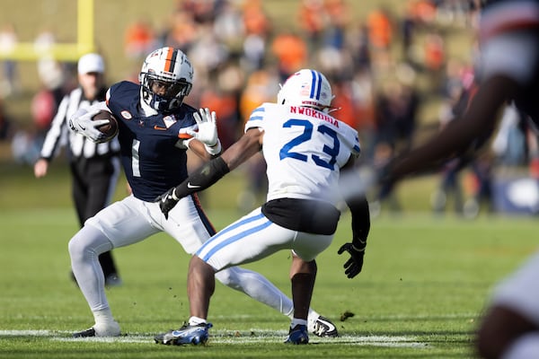 Virginia wide receiver Suderian Harrison (1) defends the ball from SMU safety Isaiah Nwokobia (23) during the second half of an NCAA college football game, Saturday, Nov. 23, 2024, in Charlottesville, Va. (AP Photo/Mike Kropf)