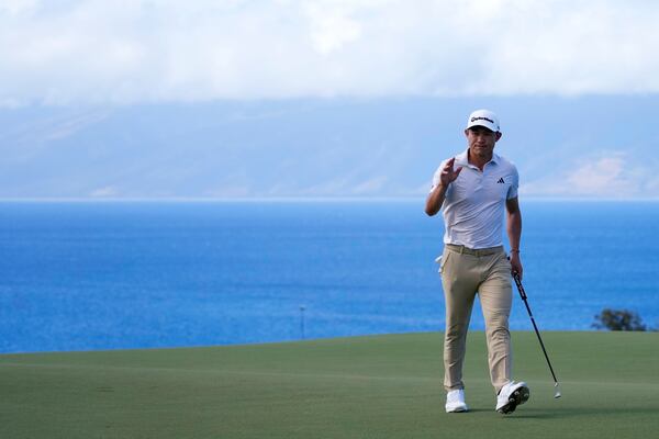 Collin Morikawa waves to the gallery after making a birdie putt at the 10th hole during the second round of The Sentry golf event, Friday, Jan. 3, 2025, at the Kapalua Plantation Course in Kapalua, Hawaii. (AP Photo/Matt York)