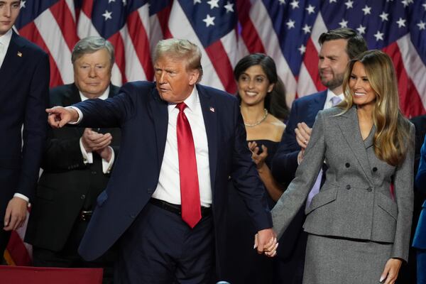 Republican Presidential nominee former President Donald Trump holds hands with former first lady Melania Trump after speaking to supporters at the Palm Beach County Convention Center during an election night watch party, Wednesday, Nov. 6, 2024, in West Palm Beach, Fla. (AP Photo/Lynne Sladky)