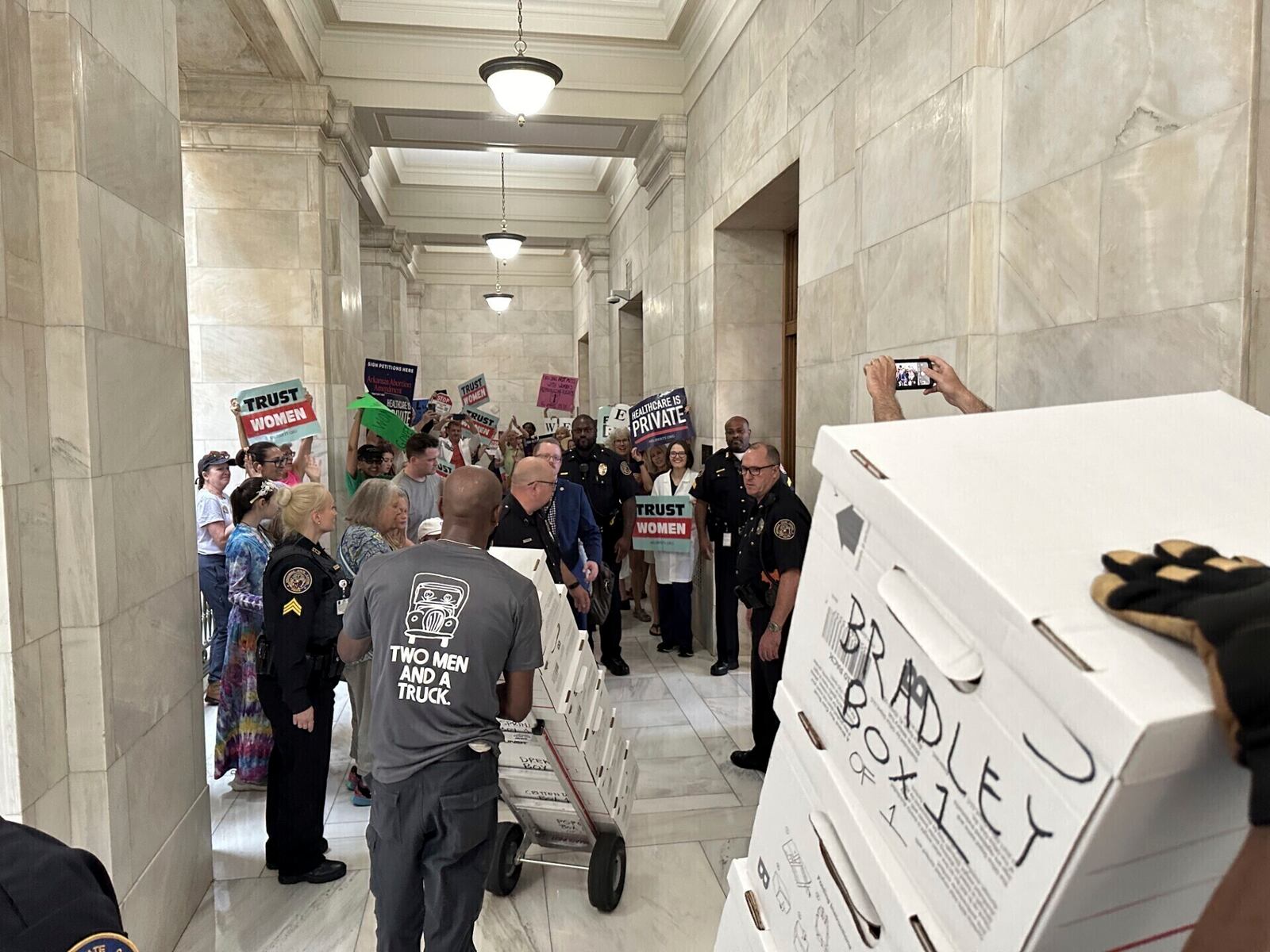 FILE - Boxes containing signatures supporting a proposed ballot measure to scale back Arkansas' abortion ban are delivered to a room in the state Capitol, July 5, 2024, in Little Rock, Ark. (AP Photo/Andrew DeMillo, File)