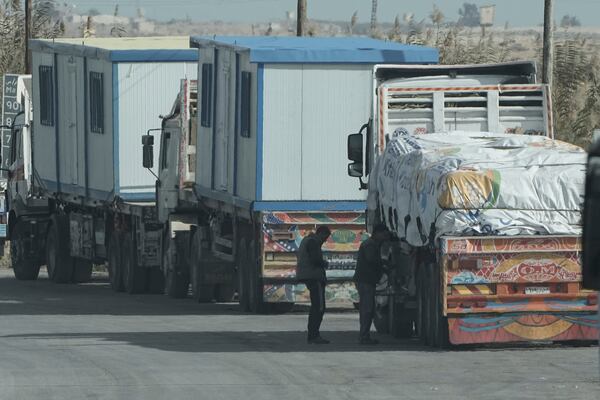 Truck drivers of humanitarian aids wait at Baloza check point, on their way to cross the Rafah border crossing between Egypt and the Gaza Strip , Sunday, Jan. 19, 2025. (AP Photo/Amr Nabil)