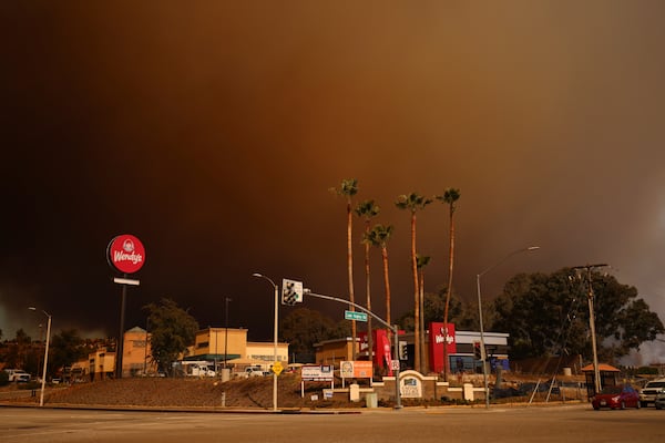 Smoke fills the sky during a wildfire on Wednesday, Jan. 22, 2025 in Castaic, Calif. (AP Photo/Ethan Swope)