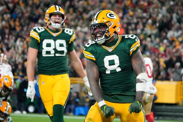 Green Bay Packers running back Josh Jacobs (8) celebrates a touchdown during the second half of an NFL football game against the San Francisco 49ers on Sunday, Nov. 24, 2024 in Green Bay, Wis. (AP Photo/Morry Gash)