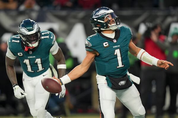 Philadelphia Eagles quarterback Jalen Hurts celebrates after scoring against the Washington Commanders during the second half of the NFC Championship NFL football game, Sunday, Jan. 26, 2025, in Philadelphia. (AP Photo/Chris Szagola)