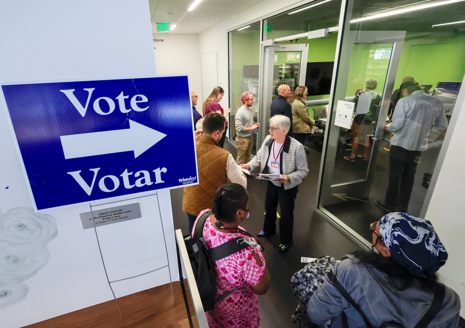 People lineup to vote on the first day of Wisconsin's in-person absentee voting at the Madison Public Library in Madison, Wisc., Tuesday, Oct. 22, 2024. (AP Photo/John Hart, Wisconsin State Journal)