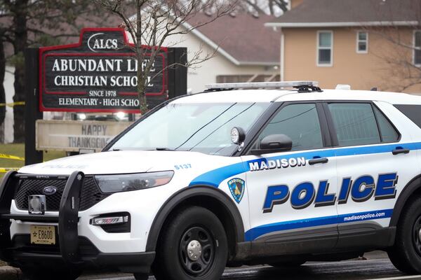 Emergency vehicles are parked outside the Abundant Life Christian School in Madison, Wis., where multiple injuries were reported following a shooting, Monday, Dec. 16, 2024. (AP Photo/Morry Gash)