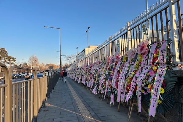 HOLD- Celebratory wreaths with messages supporting the detained President Yoon Suk Yeol line up along the street leading to his Hannam-dong residence on Thursday, Jan. 23, 2025, in Seoul. (AP Photo/Juwon Park)