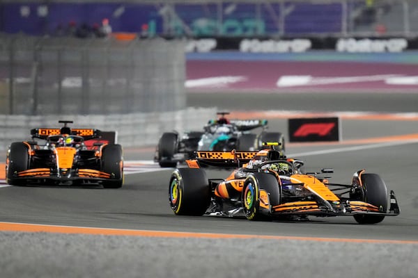 McLaren driver Lando Norris of Britain leads his teammate McLaren driver Oscar Piastri of Australia during sprint race at the Formula One Qatar Grand Prix, at the Lusail International Circuit in Lusail, Qatar, Saturday, Nov. 30, 2024. (AP Photo/ Darko Bandic)