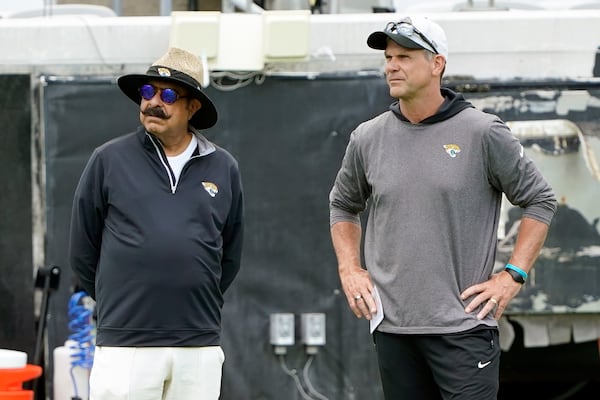 FILE - Jacksonville Jaguars owner Shad Khan, left, and general manager Trent Baalke watch players during the NFL football team's rookie minicamp, Saturday, May 14, 2022, in Jacksonville, Fla. (AP Photo/John Raoux, File)