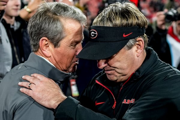 Georgia Gov. Brian Kemp speaks with Georgia head coach Kirby Smart after an NCAA college football game against Georgia Tech, Saturday, Nov. 30, 2024, in Athens, Ga. Georgia won in eight overtimes. (AP Photo/Mike Stewart)