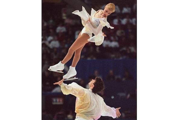 FILE - World champions Evgenia Shishkova and Vadim Naumov of Russia execute a throw during the pairs short competition at the World Figure Skating competition in Edmonton, Alberta, March 19, 1996. (Dave Buston/The Canadian Press via AP, File)