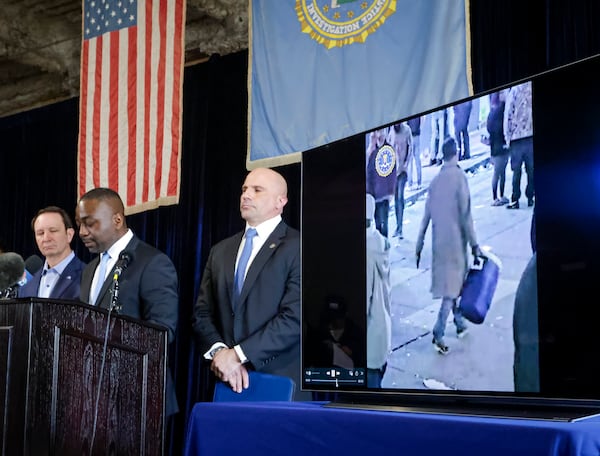 Lyonel Myrthil, special agent in charge of the New Orleans field office, second from left, shows footage of Shamsud-Din Jabbar, the man who carried out an attack on New Orleans' Bourbon Street on New Year's Day, during a news conference in a secure garage at the FBI Headquarters in New Orleans, Sunday, Jan. 5, 2025. (Scott Threlkeld/The Times-Picayune/The New Orleans Advocate via AP)