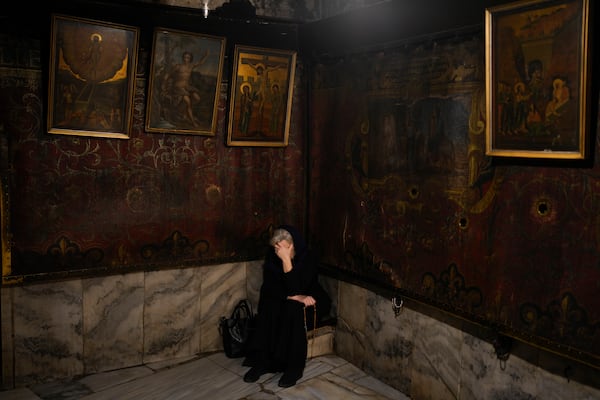 A worshipper prays in the Church of the Nativity where Christians believe Jesus Christ was born, ahead of Christmas in the West Bank city of Bethlehem, Monday, Dec. 23, 2024. (AP Photo/Matias Delacroix)