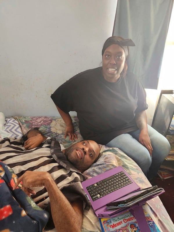 This photo courtesy of Jordan Mitchell, shows Justin Mitchell, below, with their cousin Malaya McDaniels, at his home on Christmas Eve in Altadena, California, Dec. 24, 2024. Justin Mitchell, and his father Anthony, died in California's deadly wildfires in January 2025. (Jordan Mitchell via AP)