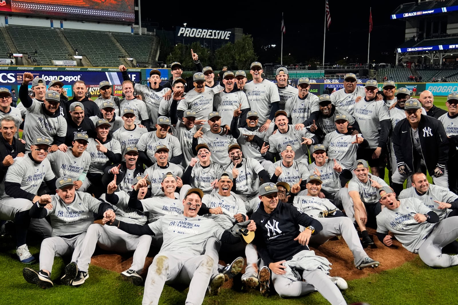 New York Yankees players pose for a team picture after Game 5 of the baseball AL Championship Series against the Cleveland Guardians Saturday, Oct. 19, 2024, in Cleveland. The Yankees won 5-2 to advance to the World Series. (AP Photo/Sue Ogrocki)