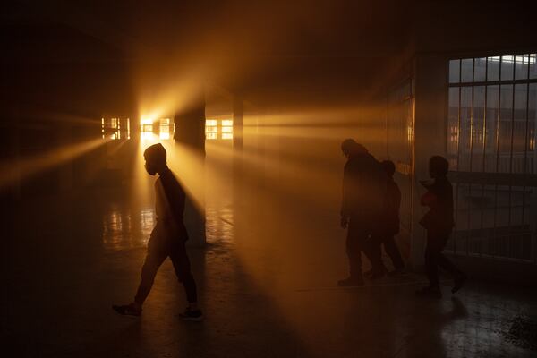 FILE - The setting sun casts a warm glow through the windows of the infamous Saydnaya military prison in the outskirts of Damascus, Syria, Wednesday, Dec. 18, 2024. (AP Photo/Leo Correa, File)