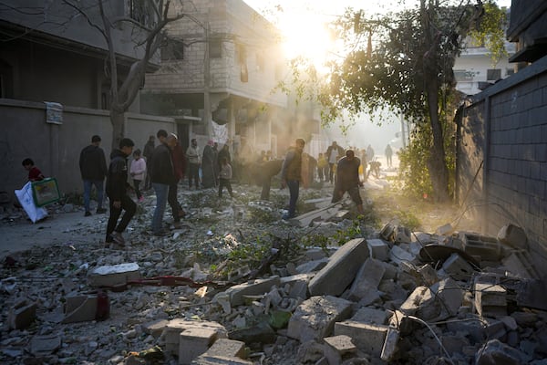 Palestinians inspect the site of an Israeli army strike early Tuesday morning in Deir Al-Balah in the central Gaza Strip, Tuesday, Jan. 14, 2025. (AP Photo/Abdel Kareem Hana)