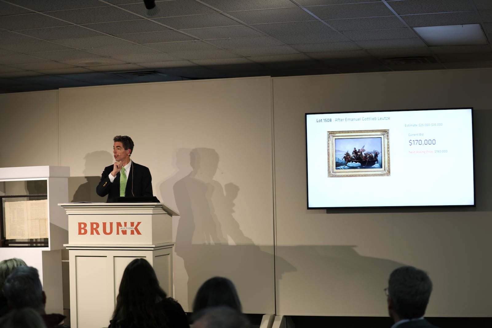 Brunk Auctions owner Andrew Brunk takes bids for a copy of a painting shortly before a 1787 copy of the U.S. Constitution was sold for $9 million in Asheville, N.C., on Thursday, Oct. 17, 2024. (AP Photo/Jeffrey Collins)